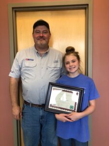 4-H'er holding certificate with local Extension Director