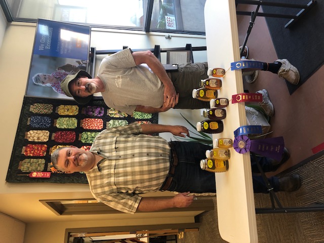 local Extension Director with local honey producer showing fair ribbons