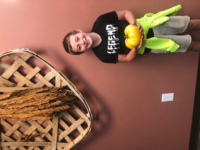 Youth showing off his giant tomato