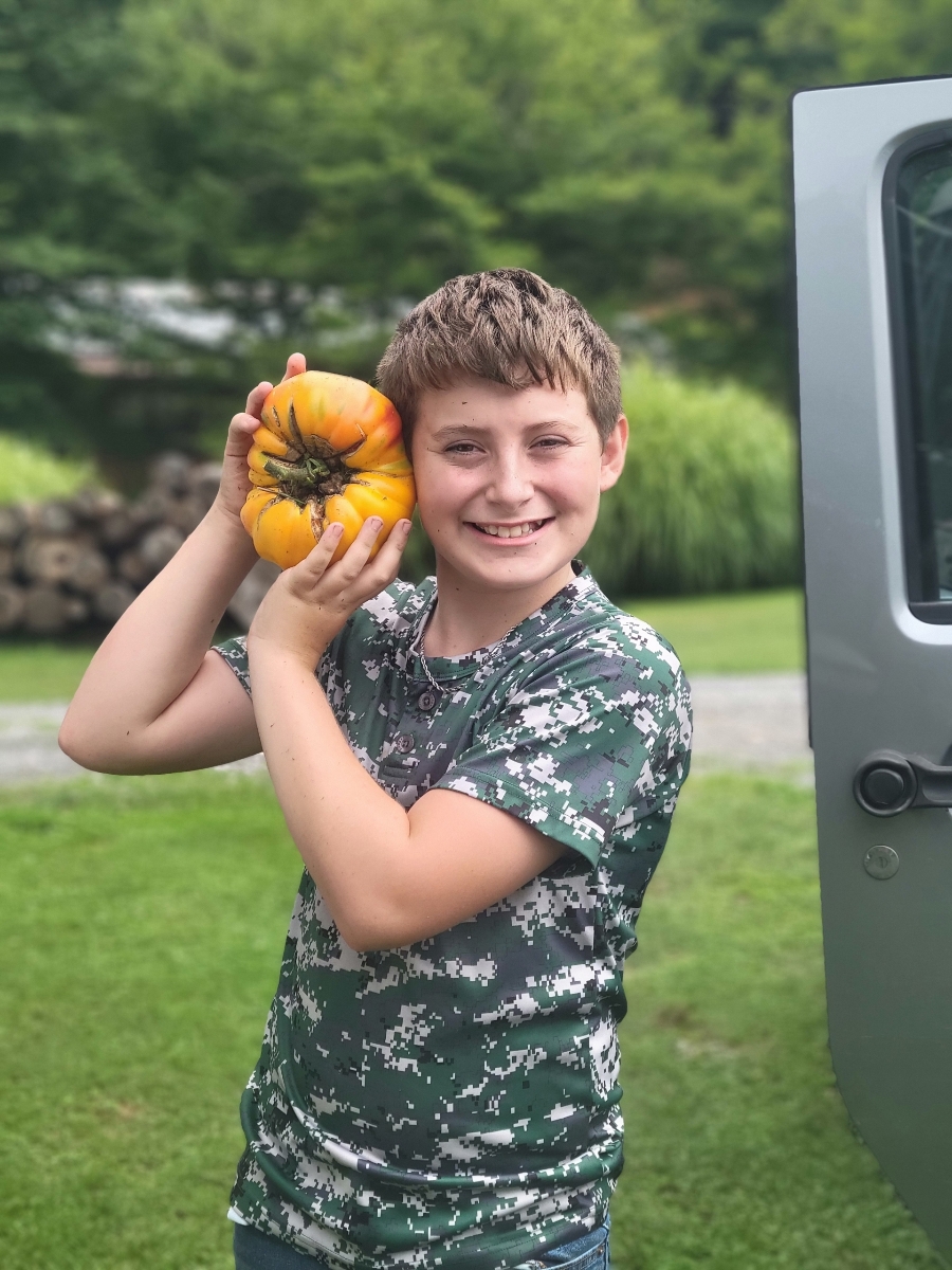 Tomato Contest WInner with his winning tomato