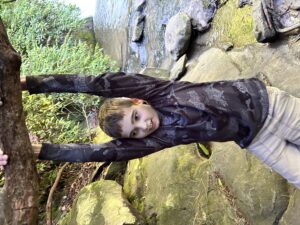 a 4-H'er swinging on tree branch on a hike