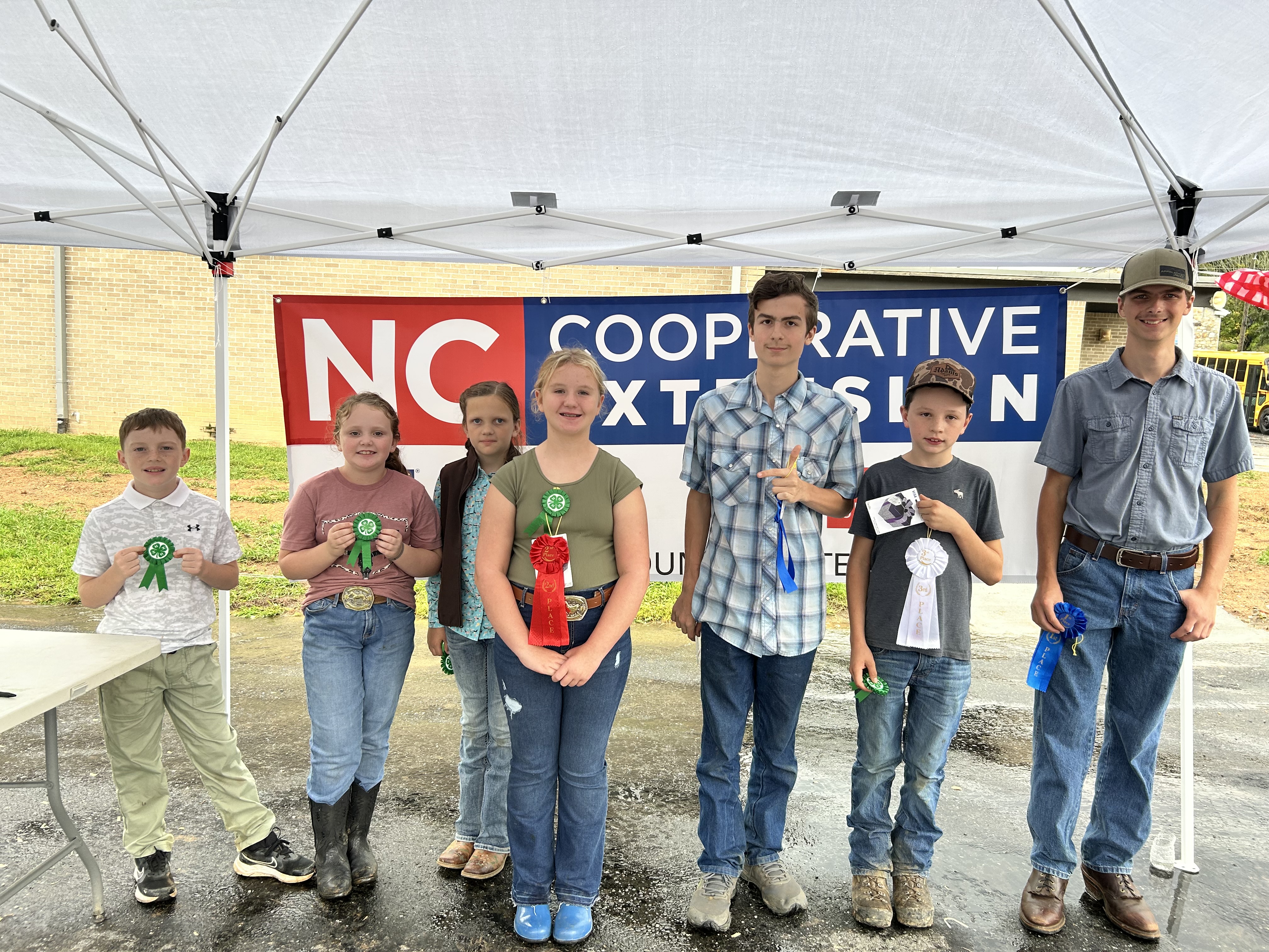 youth participants presenting their ribbons & awards for participating in poultry show